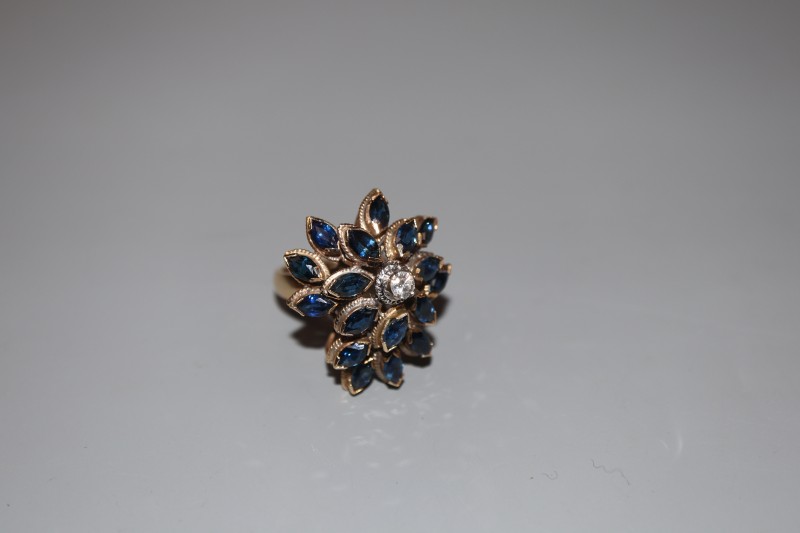 A 14k yellow metal, sapphire and diamond set raised cluster dress ring, of flowerhead design, size M, gross weight 9.2 grams.